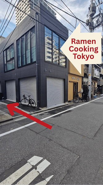Goal: You've Arrived!: Ramen Cooking Tokyo is located on the second floor of a black, two-story building. This is where your ramen-cooking experience begins!